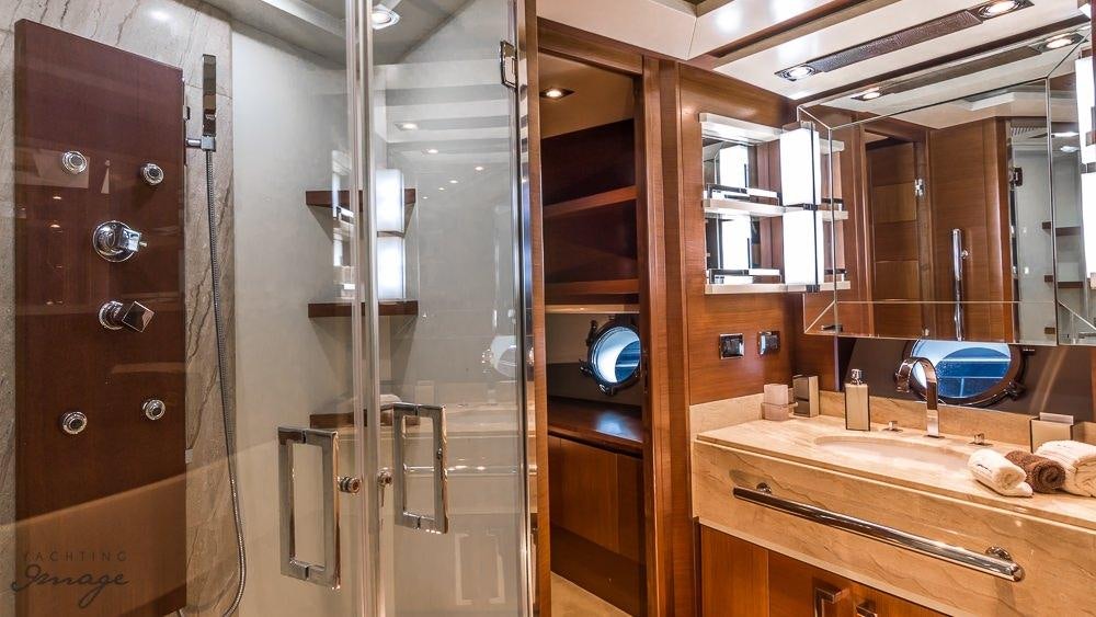 a bathroom with a shower unit and sink aboard 105 YCG Yacht for Charter