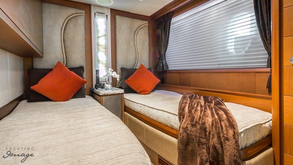 a couple of beds in a room aboard 105 YCG Yacht for Charter