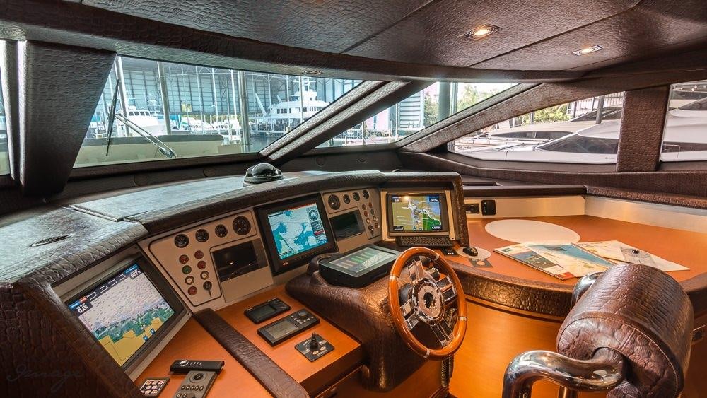 a desk with computers and monitors aboard 105 YCG Yacht for Charter