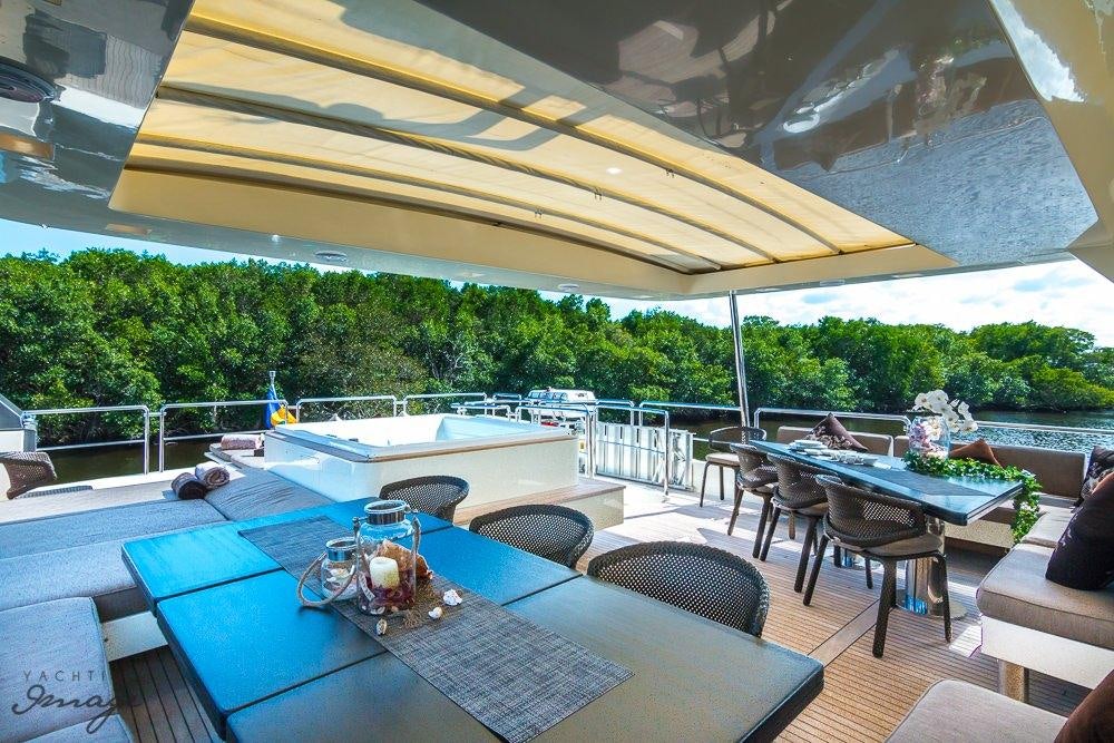 a patio with a table and chairs aboard 105 YCG Yacht for Charter