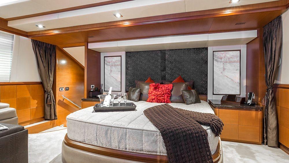 a bedroom with a large bed aboard 105 YCG Yacht for Charter
