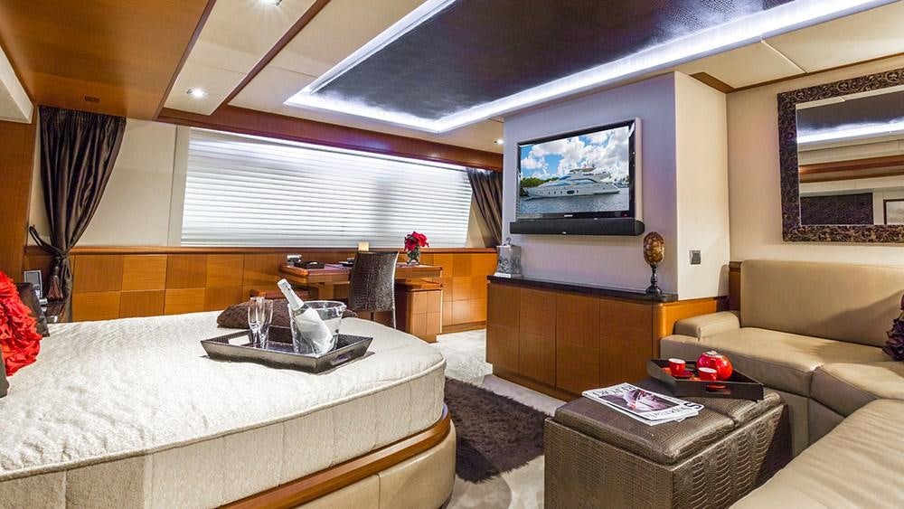 a bedroom with a bed and a tv aboard 105 YCG Yacht for Charter