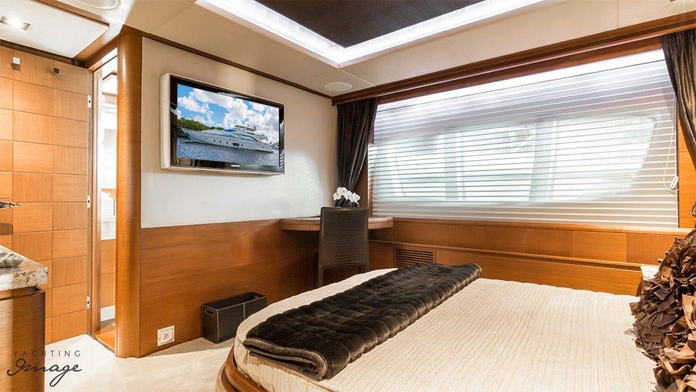a room with a tv and a bed aboard 105 YCG Yacht for Charter