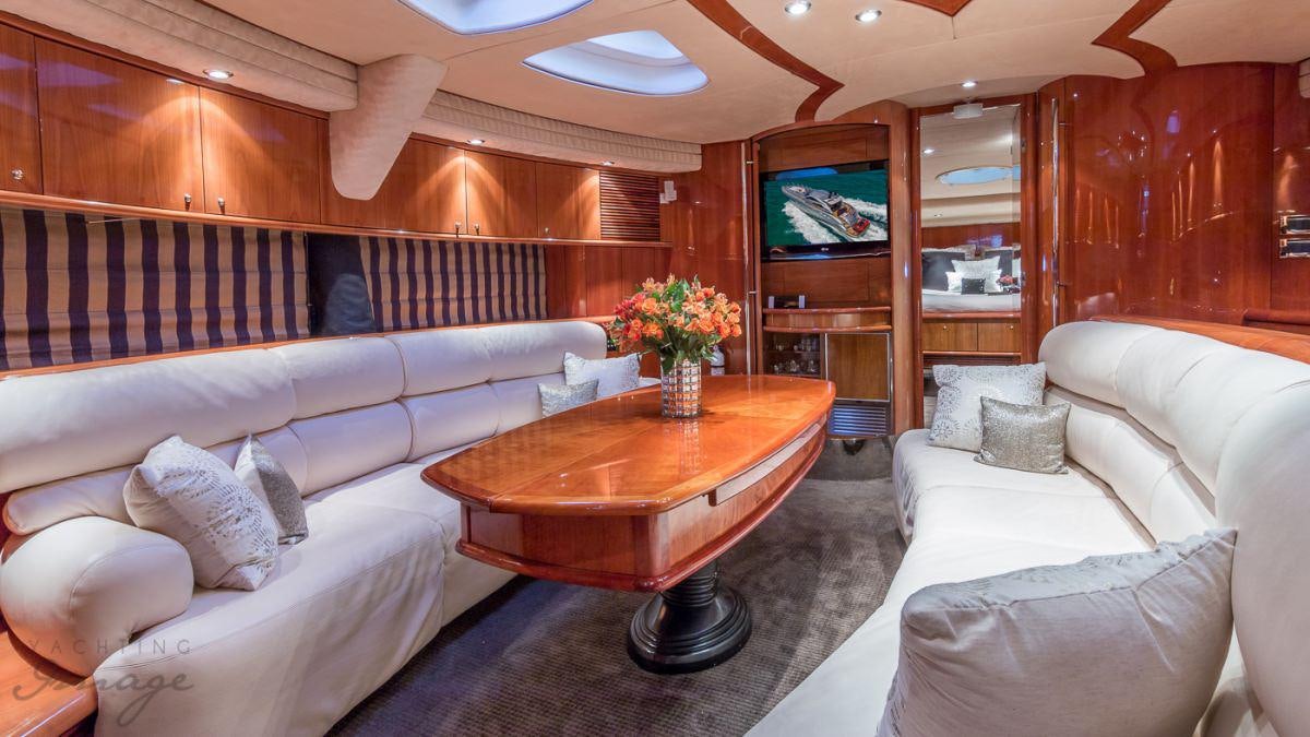 a living room with a couch and a coffee table aboard H2 Yacht for Charter