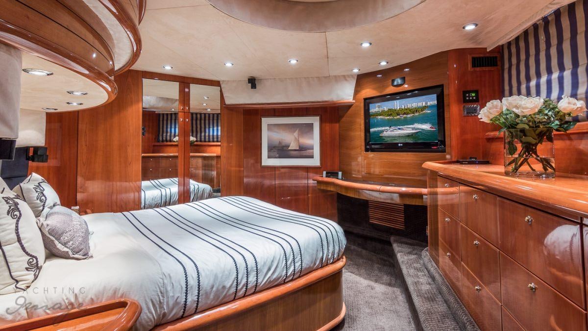 a bedroom with a bed and a tv aboard H2 Yacht for Charter