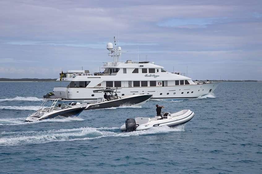 a large white boat with a smaller boat on it aboard SWEET ESCAPE Yacht for Charter