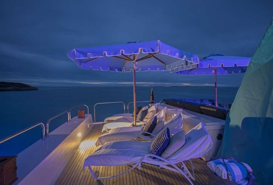 a boat with a beach and umbrellas on it aboard SWEET ESCAPE Yacht for Charter