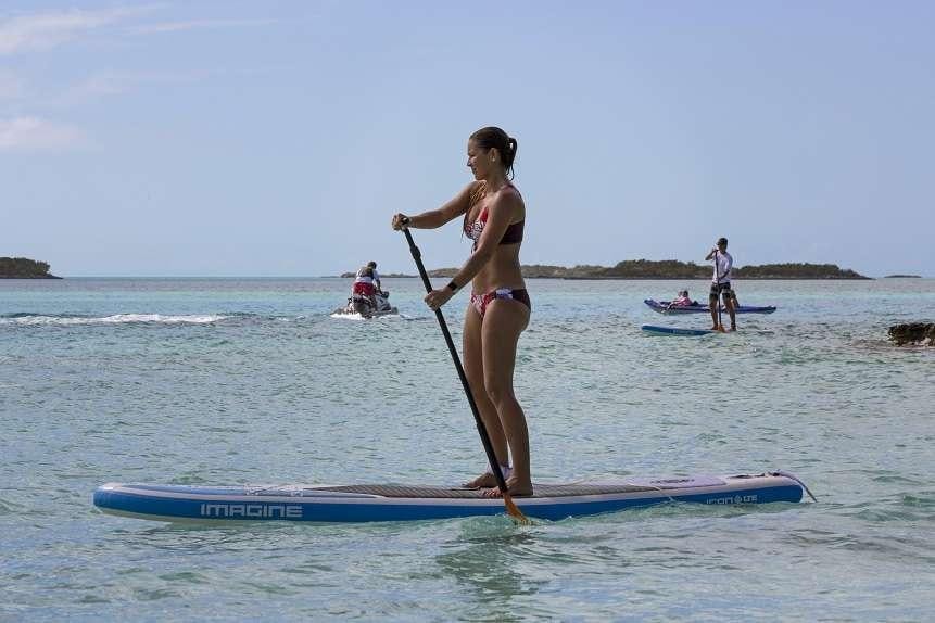 a person in a bikini on a surfboard aboard SWEET ESCAPE Yacht for Charter