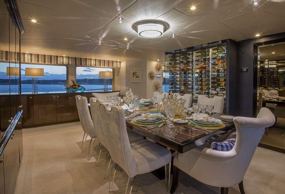 a room with a table chairs and a tv aboard SWEET ESCAPE Yacht for Charter
