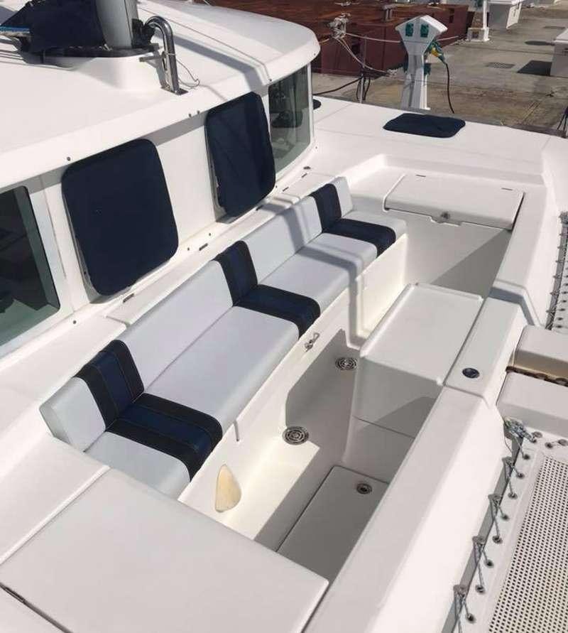 a group of white chairs aboard ALTITUDE ADJUSTMENT Yacht for Charter