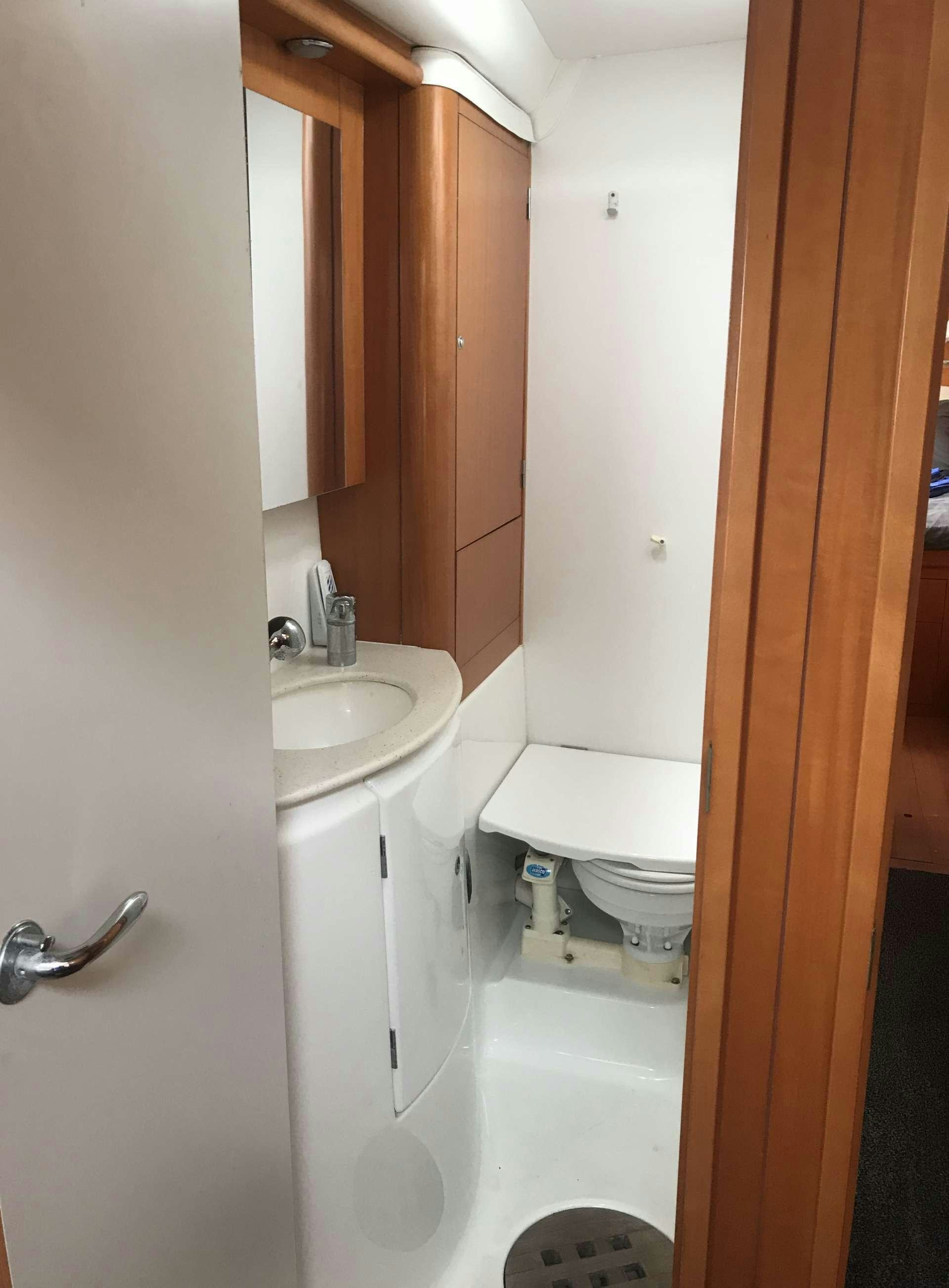 a bathroom with a toilet and sink aboard ALTITUDE ADJUSTMENT Yacht for Charter