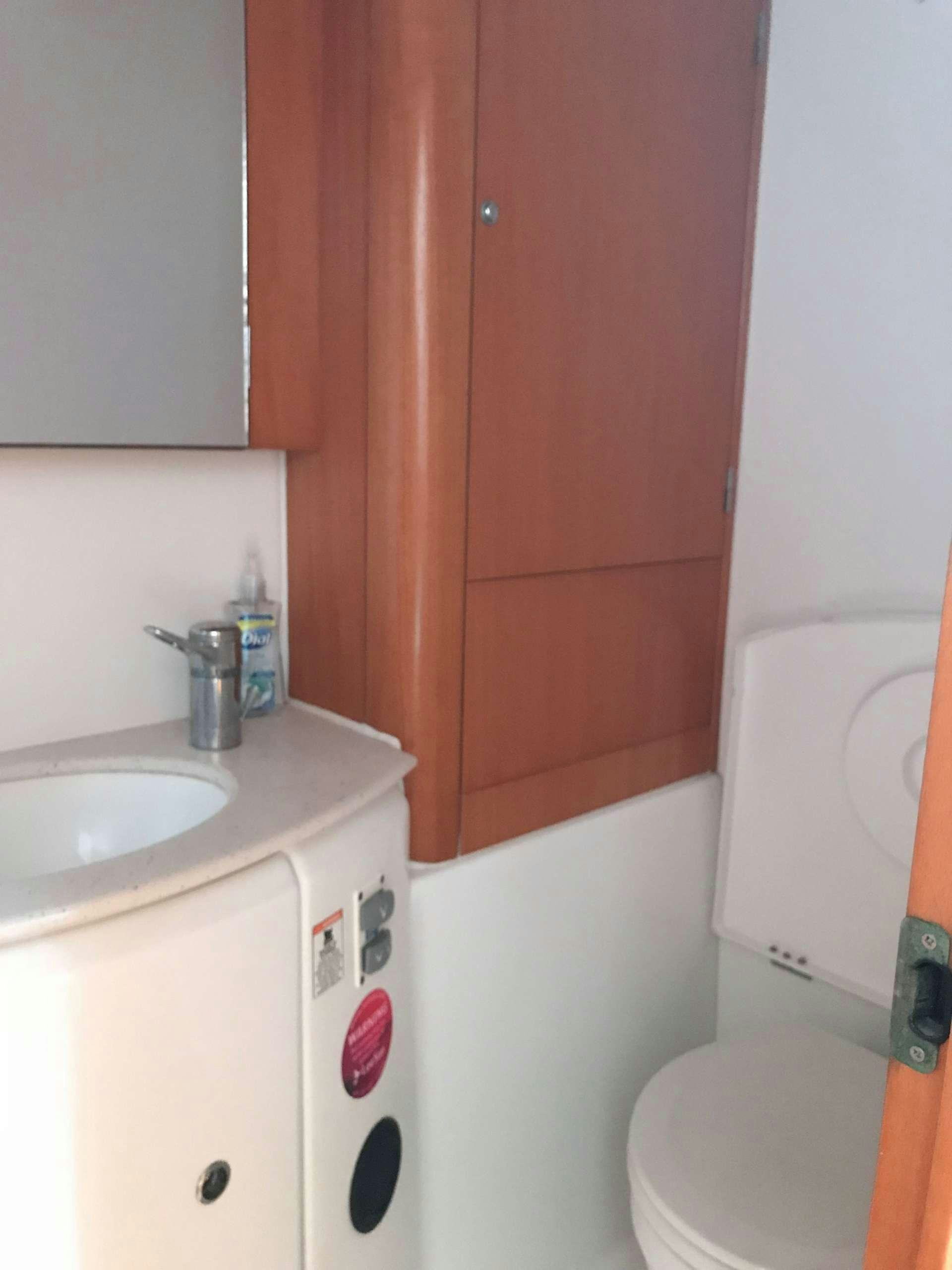 a bathroom with a toilet and sink aboard ALTITUDE ADJUSTMENT Yacht for Charter
