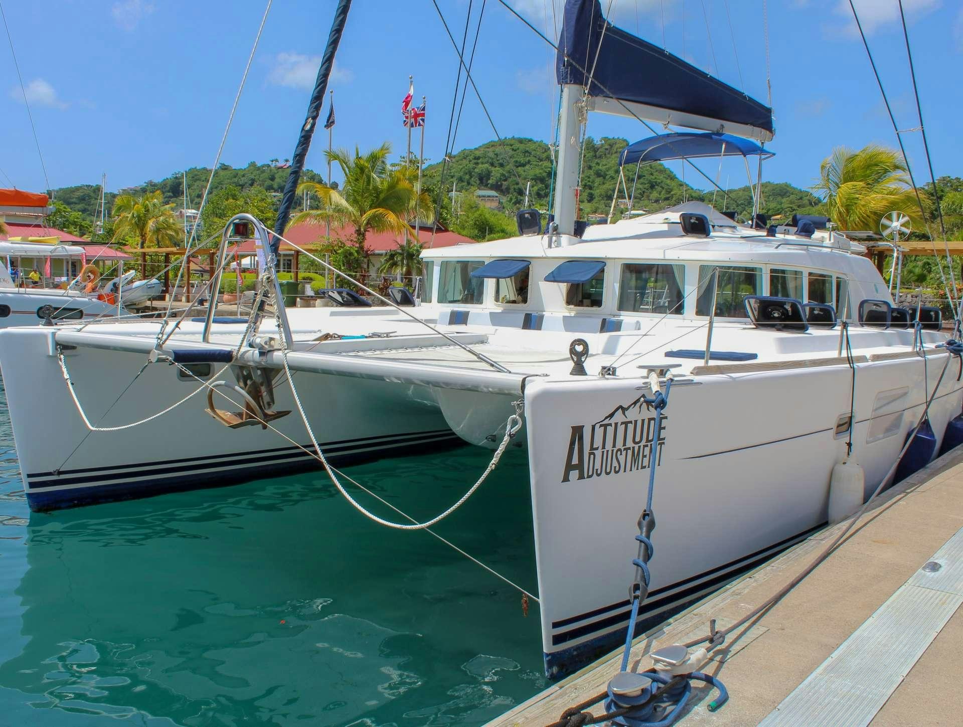 a white boat docked at a pier aboard ALTITUDE ADJUSTMENT Yacht for Charter