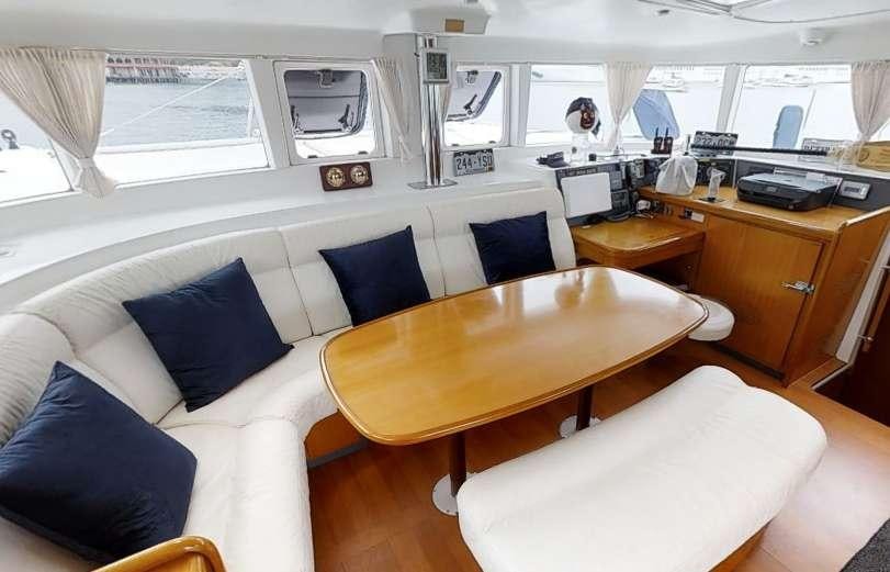 a room with a table and chairs aboard ALTITUDE ADJUSTMENT Yacht for Charter