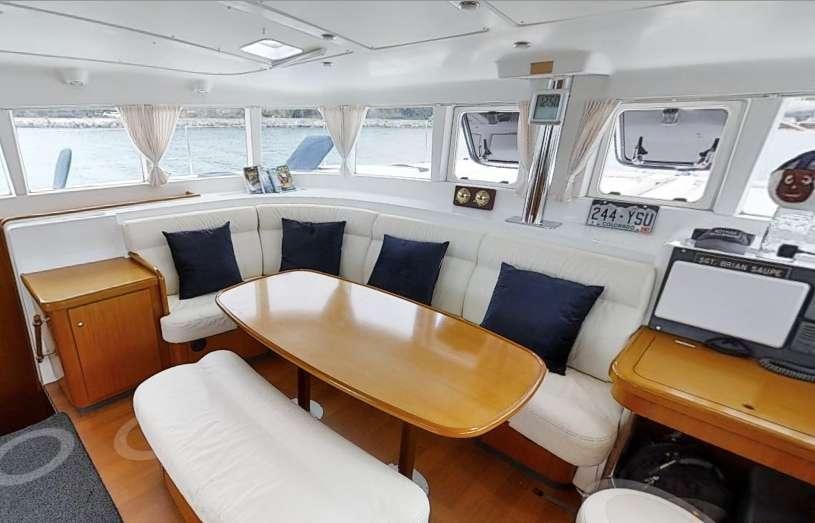 a room with a table chairs and a large window aboard ALTITUDE ADJUSTMENT Yacht for Charter