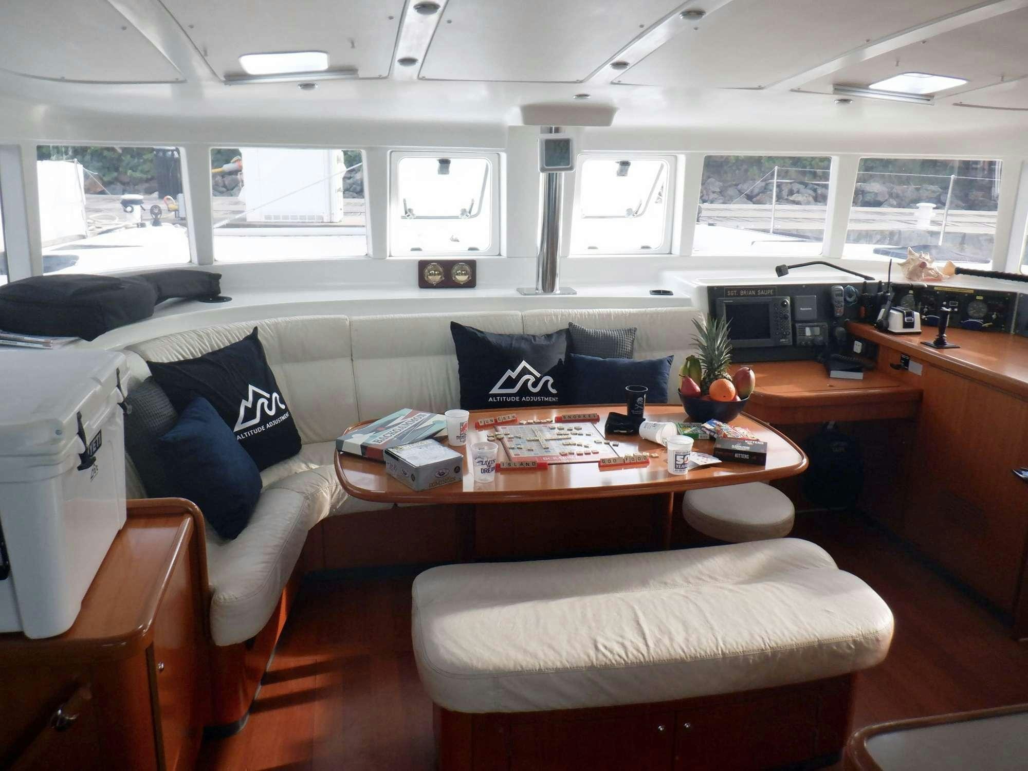 a living room with a couch and a coffee table aboard ALTITUDE ADJUSTMENT Yacht for Charter