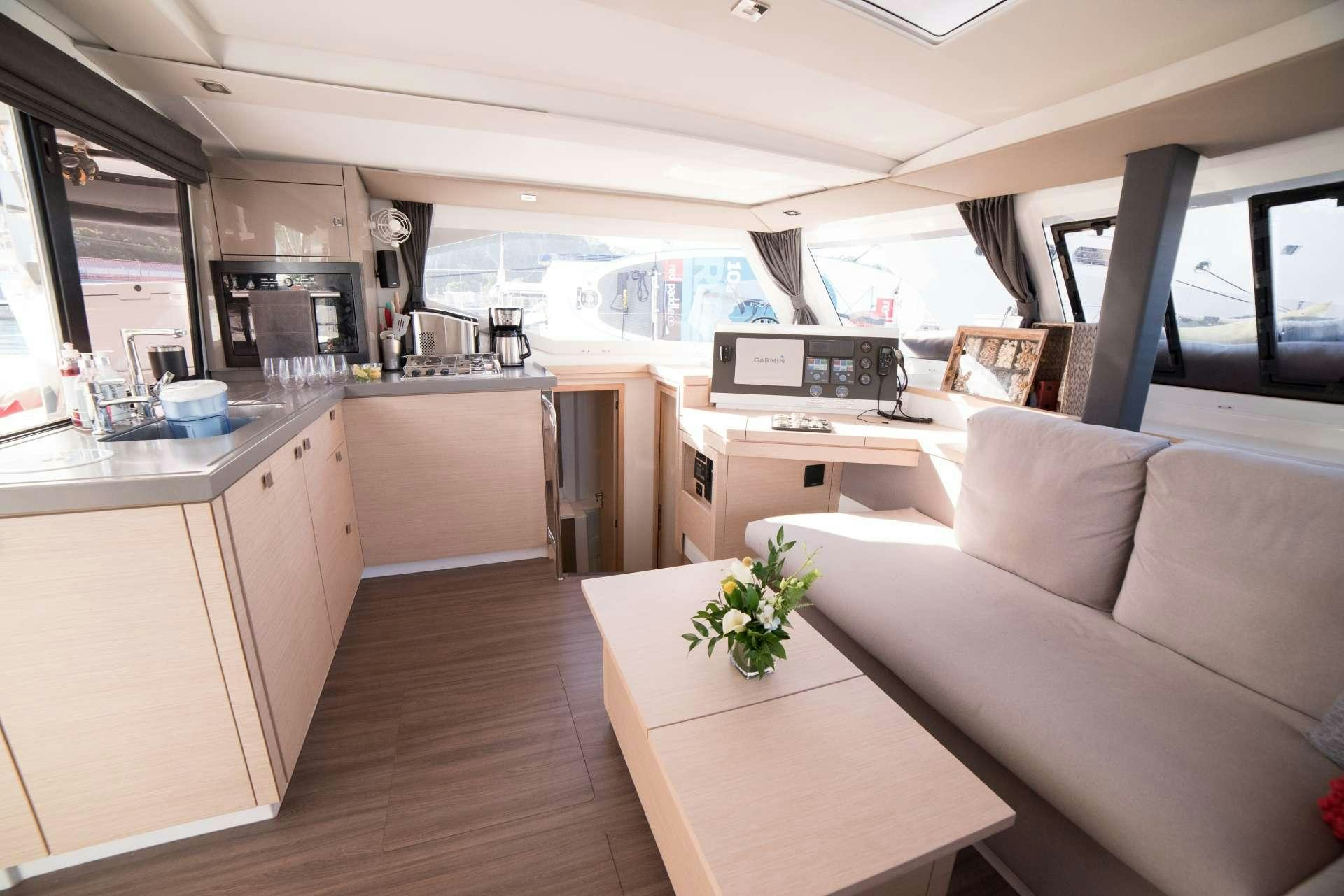 a living room with a couch and a table aboard 3 SISTERS Yacht for Charter