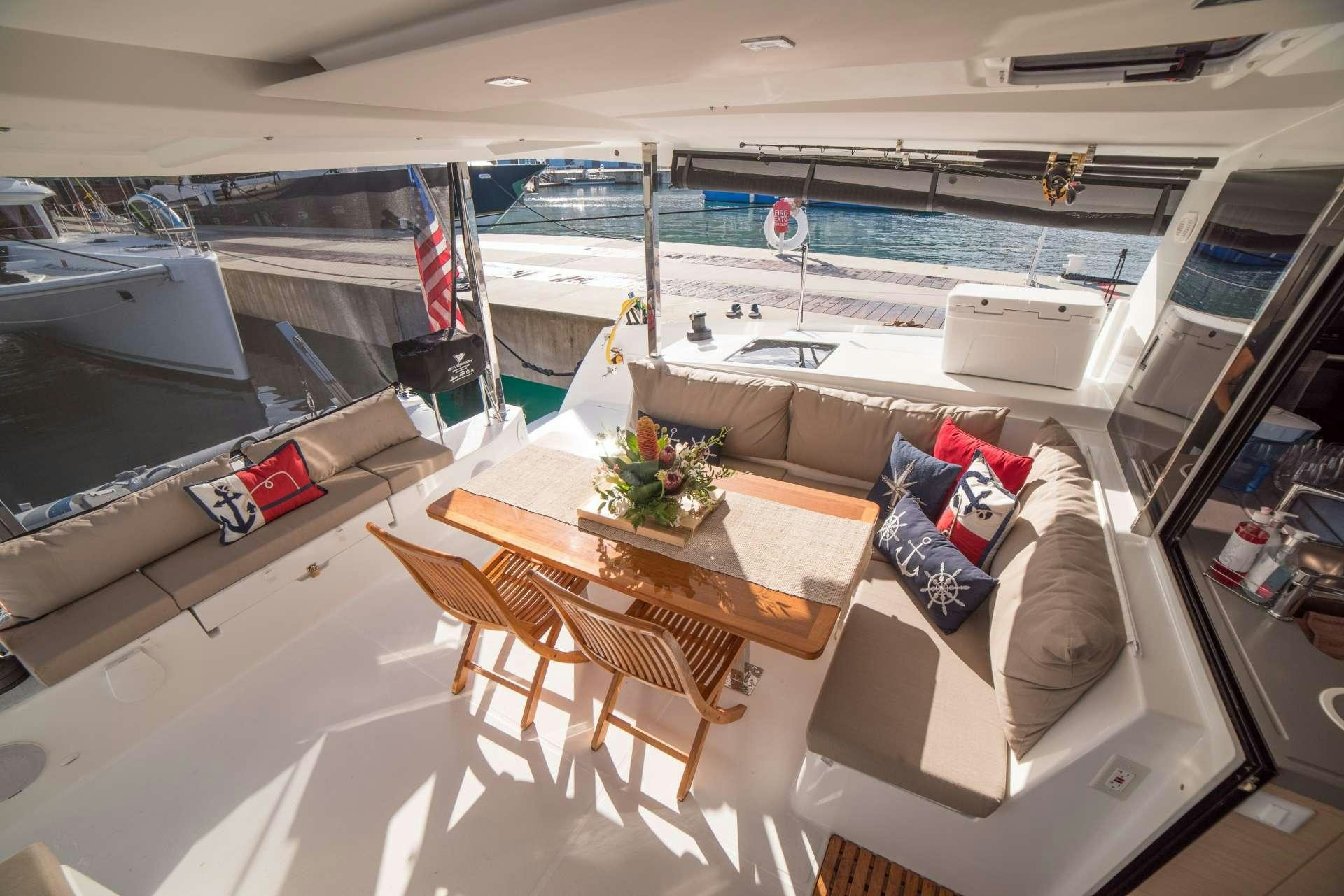 a living room with a couch and a table aboard 3 SISTERS Yacht for Charter