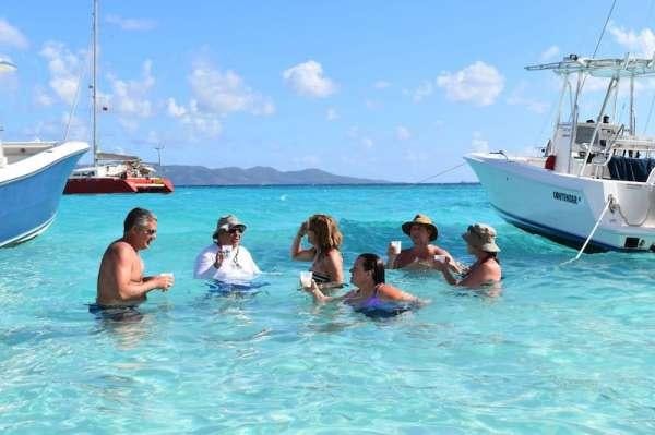 a group of people in a body of water aboard 3 SISTERS Yacht for Charter