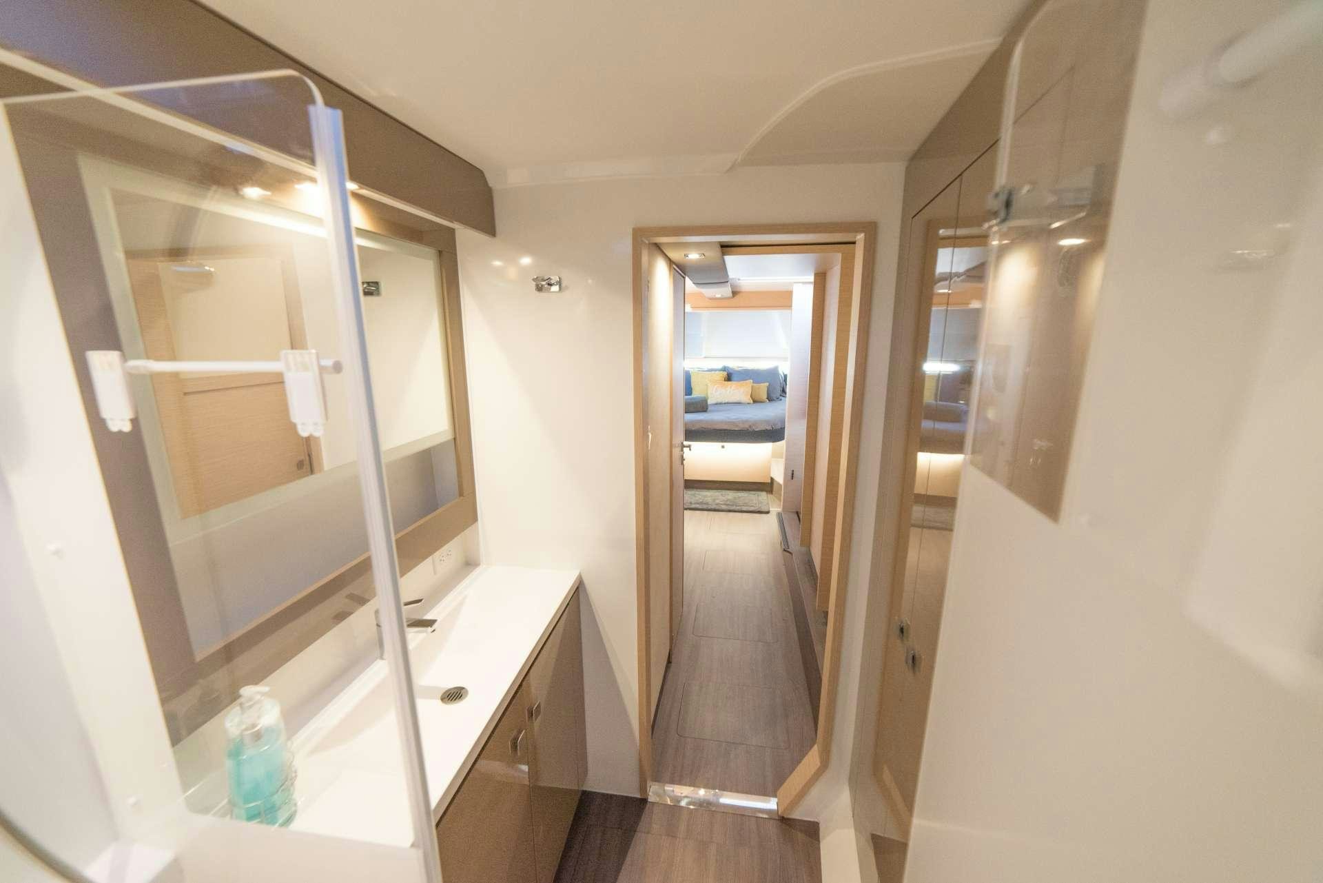 a bathroom with a large mirror aboard 3 SISTERS Yacht for Charter