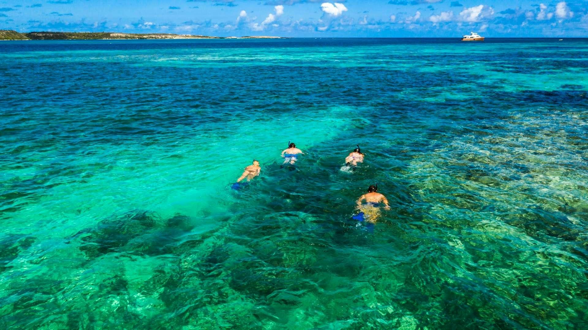 a group of people swimming in a body of water aboard EROS Yacht for Charter