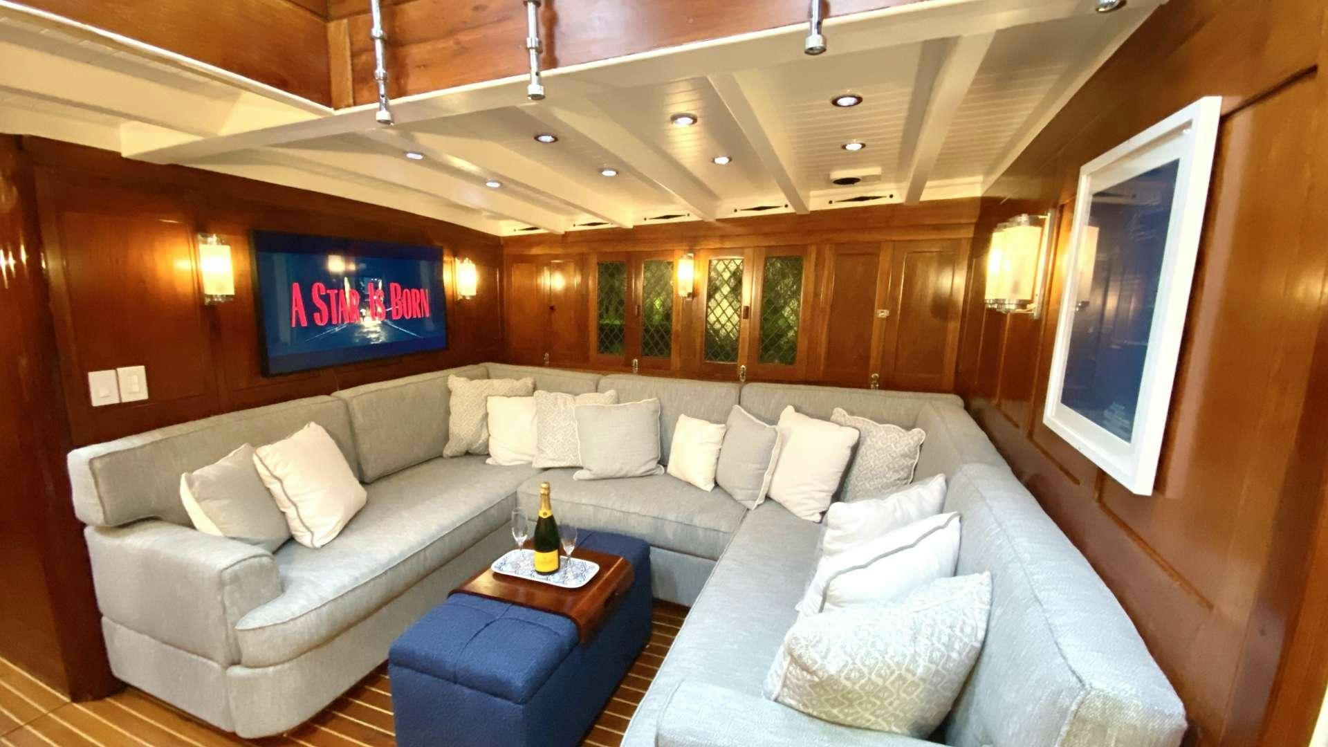 a room with a couch and a table aboard EROS Yacht for Charter
