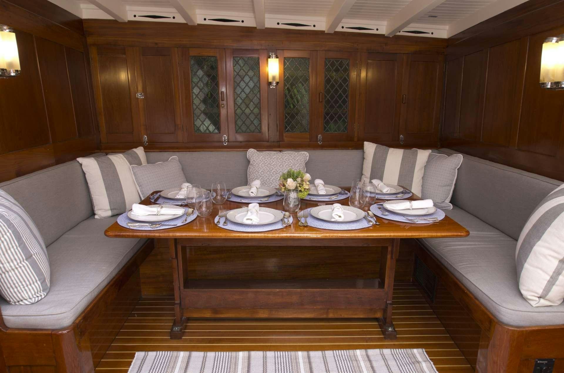 a dining table in a room aboard EROS Yacht for Charter