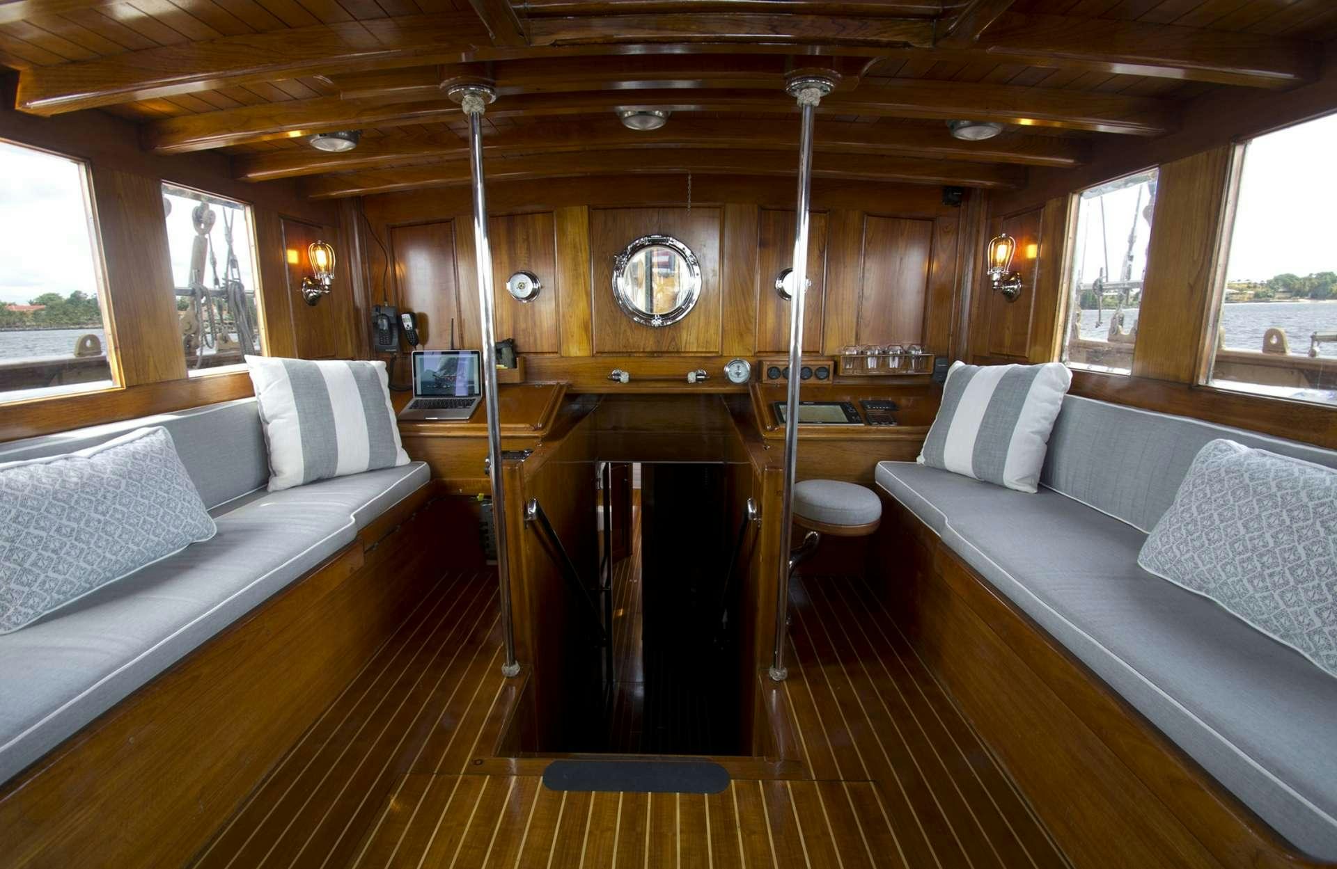 a boat with a bed and a couch aboard EROS Yacht for Charter