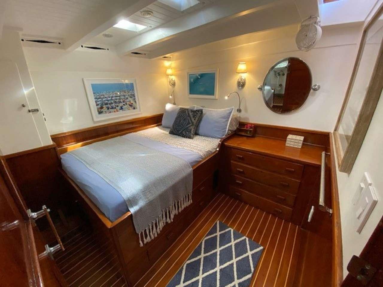 a bed in a room aboard EROS Yacht for Charter