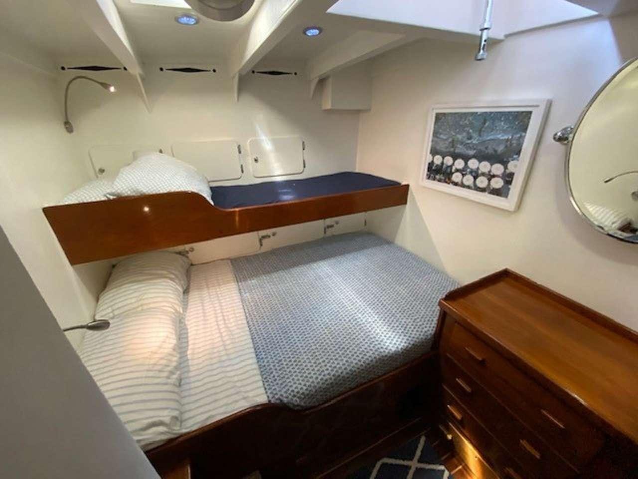 a bed with a mirror above it aboard EROS Yacht for Charter