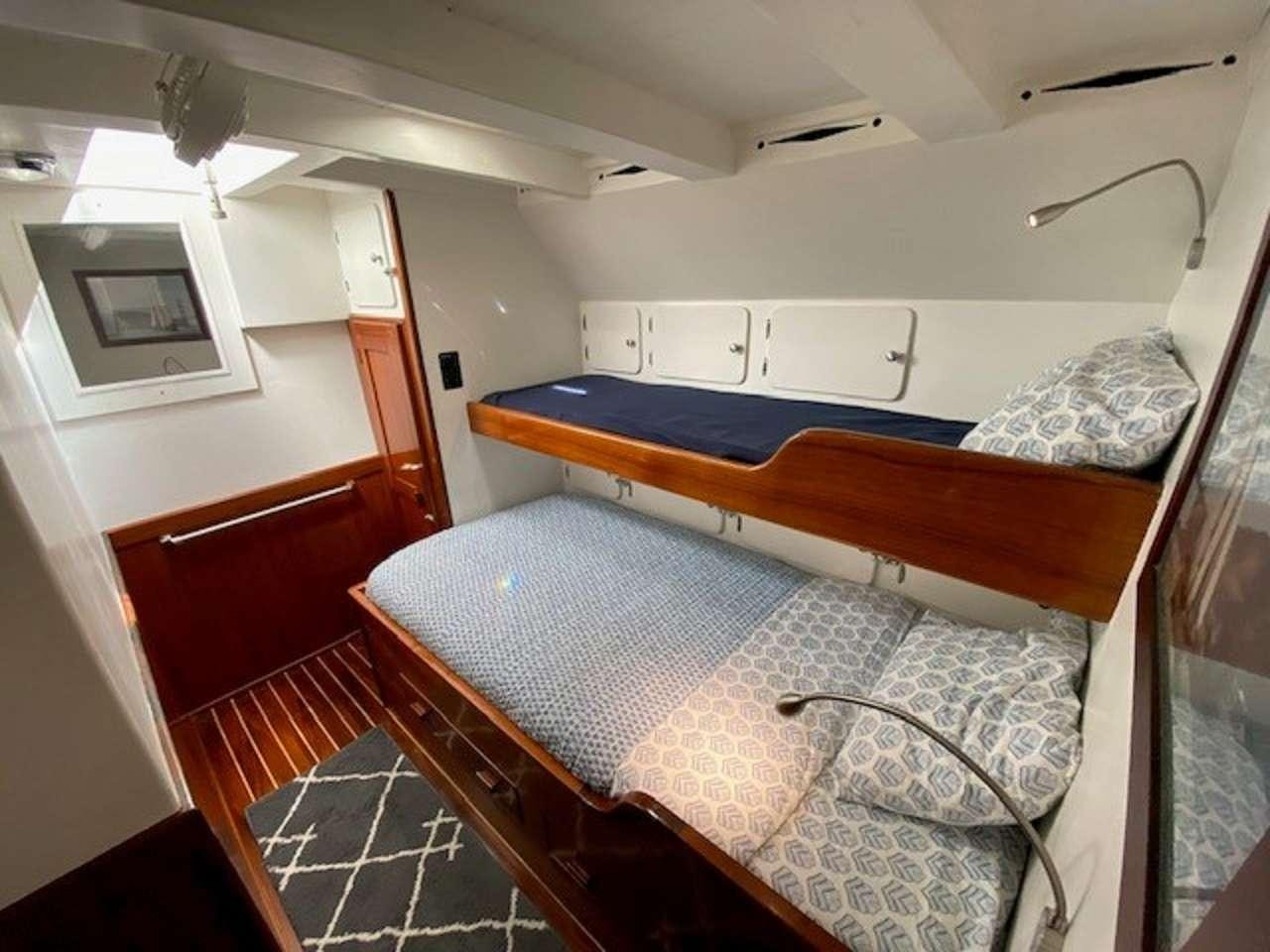 a room with two beds aboard EROS Yacht for Charter