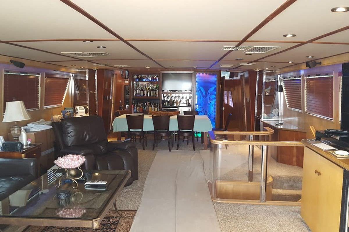 a room with a couch and a table and chairs aboard PURE KNIGHT LIFE Yacht for Charter