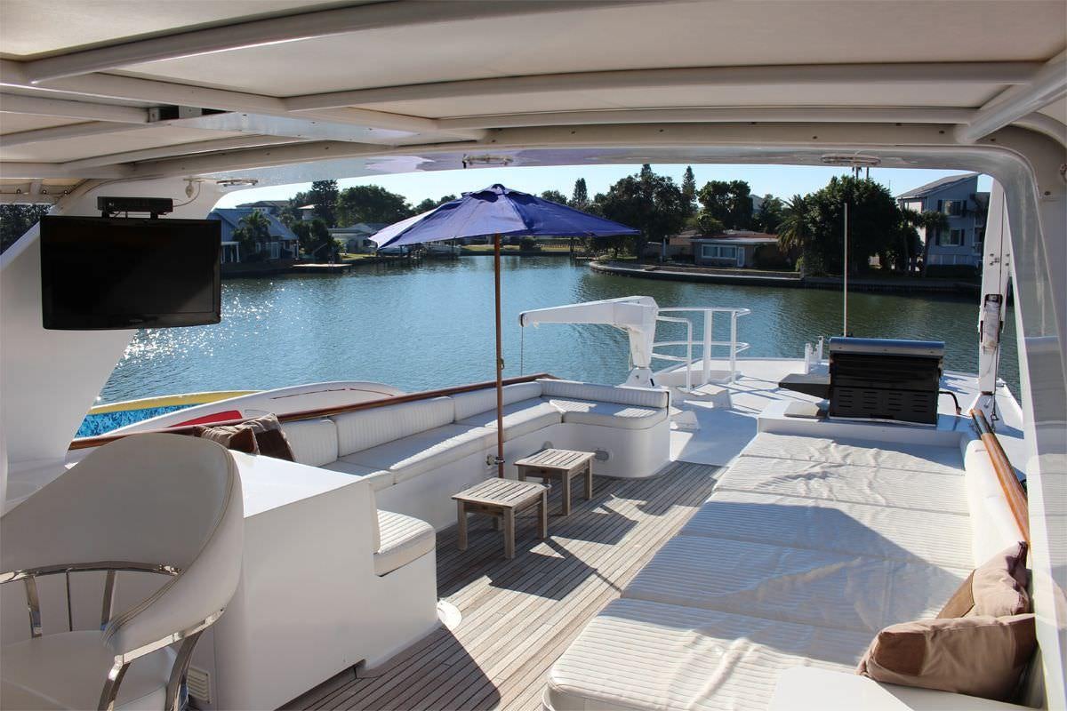 a pool with a deck and umbrella aboard PURE KNIGHT LIFE Yacht for Charter