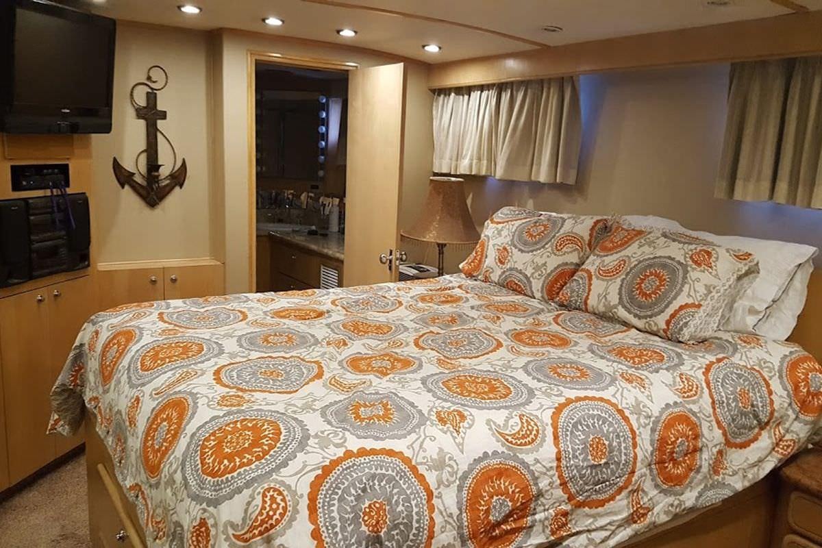 a bed with a floral pattern aboard PURE KNIGHT LIFE Yacht for Charter