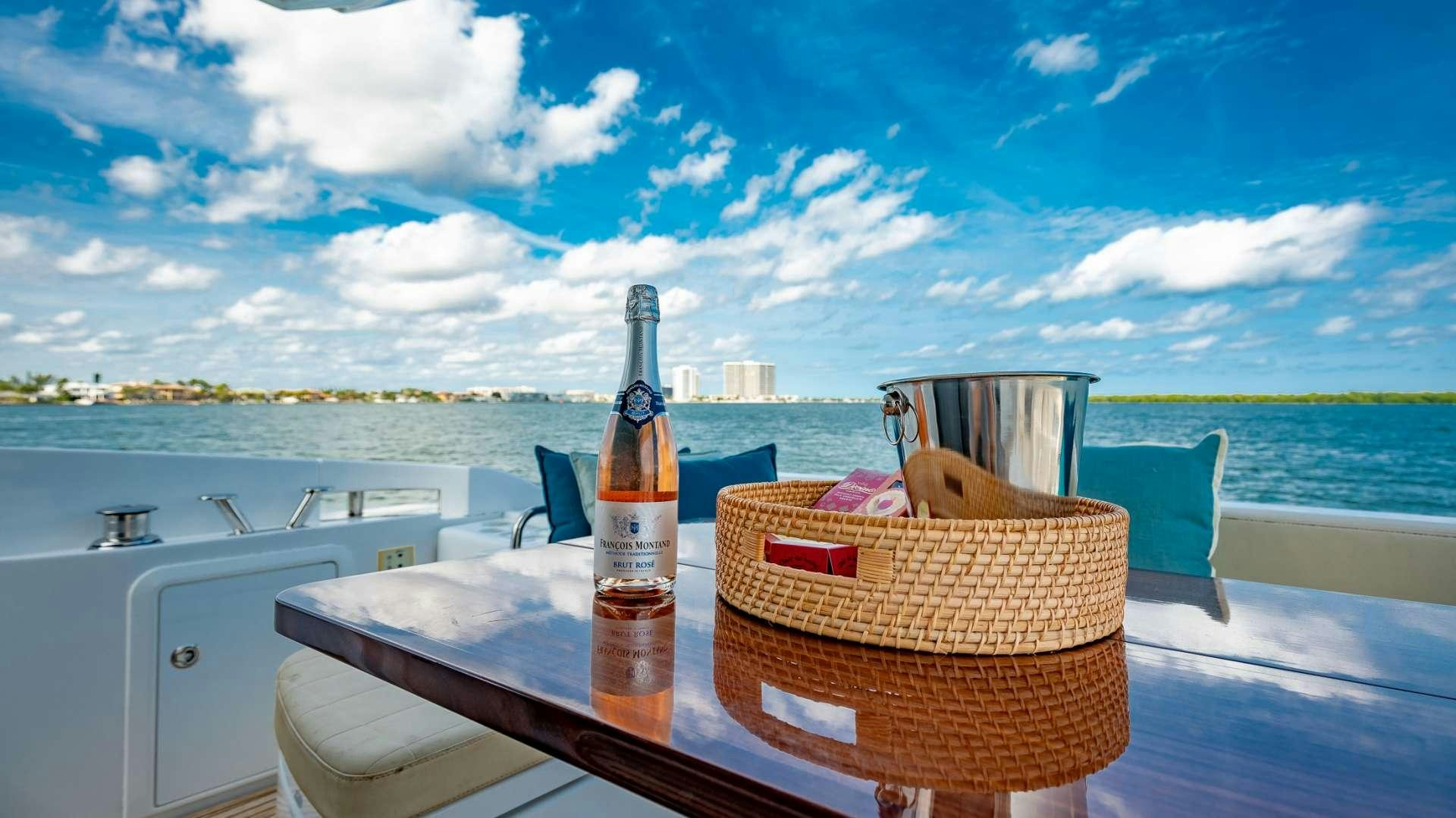 a bottle of wine on a table aboard ROLLIN DEEP Yacht for Charter