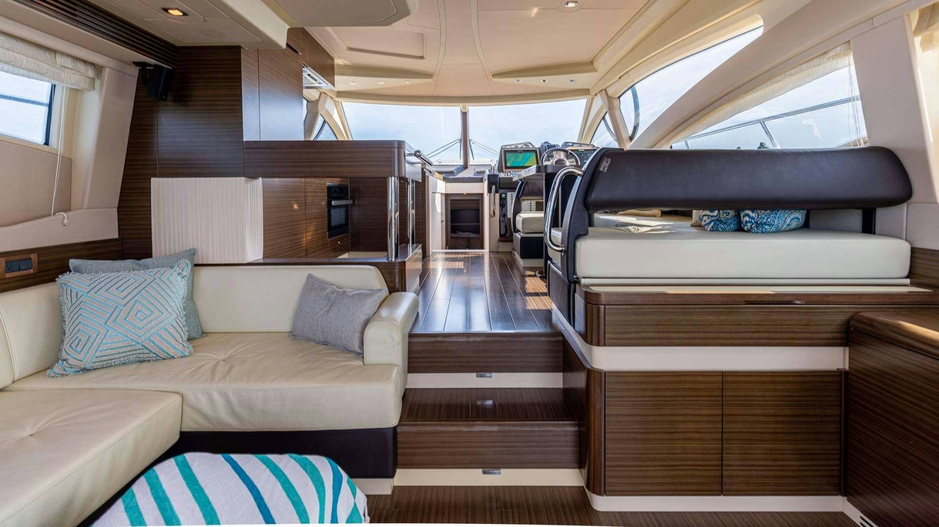 a room with a couch and a bed aboard ROLLIN DEEP Yacht for Charter