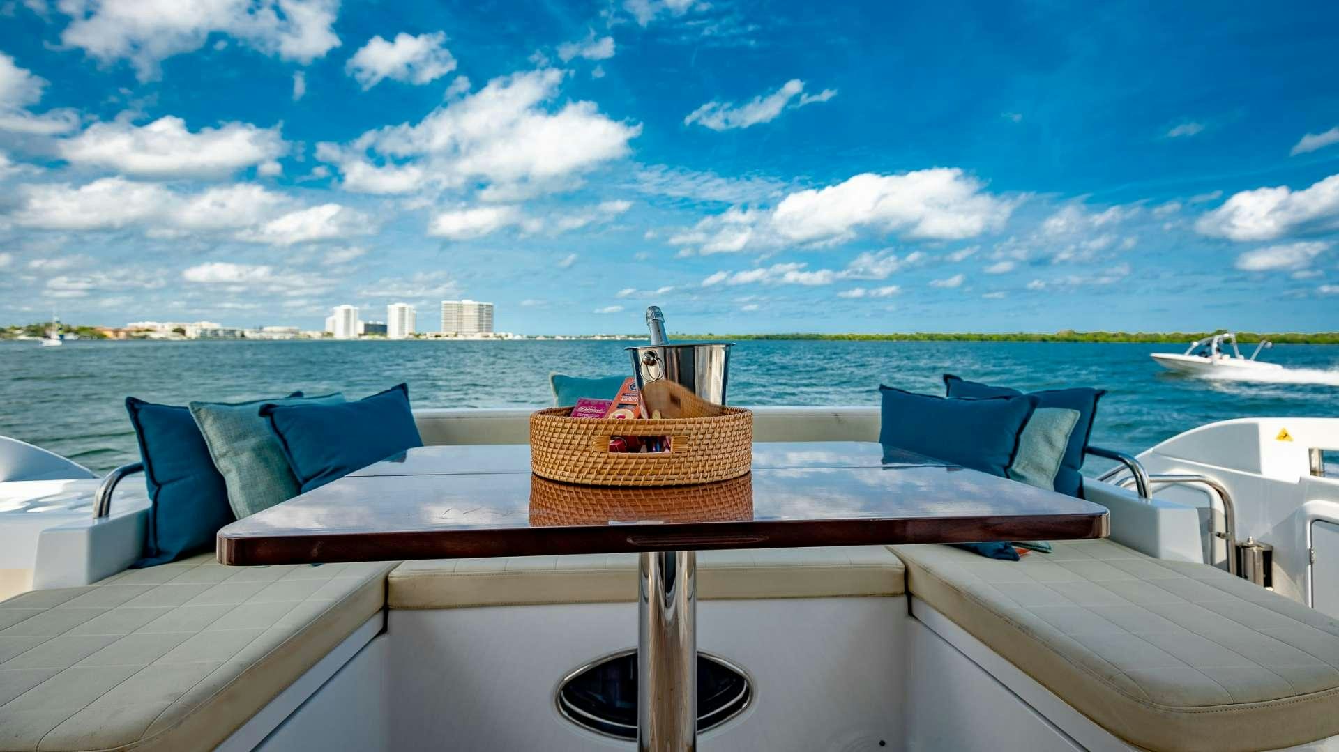 a table with chairs on it aboard ROLLIN DEEP Yacht for Charter