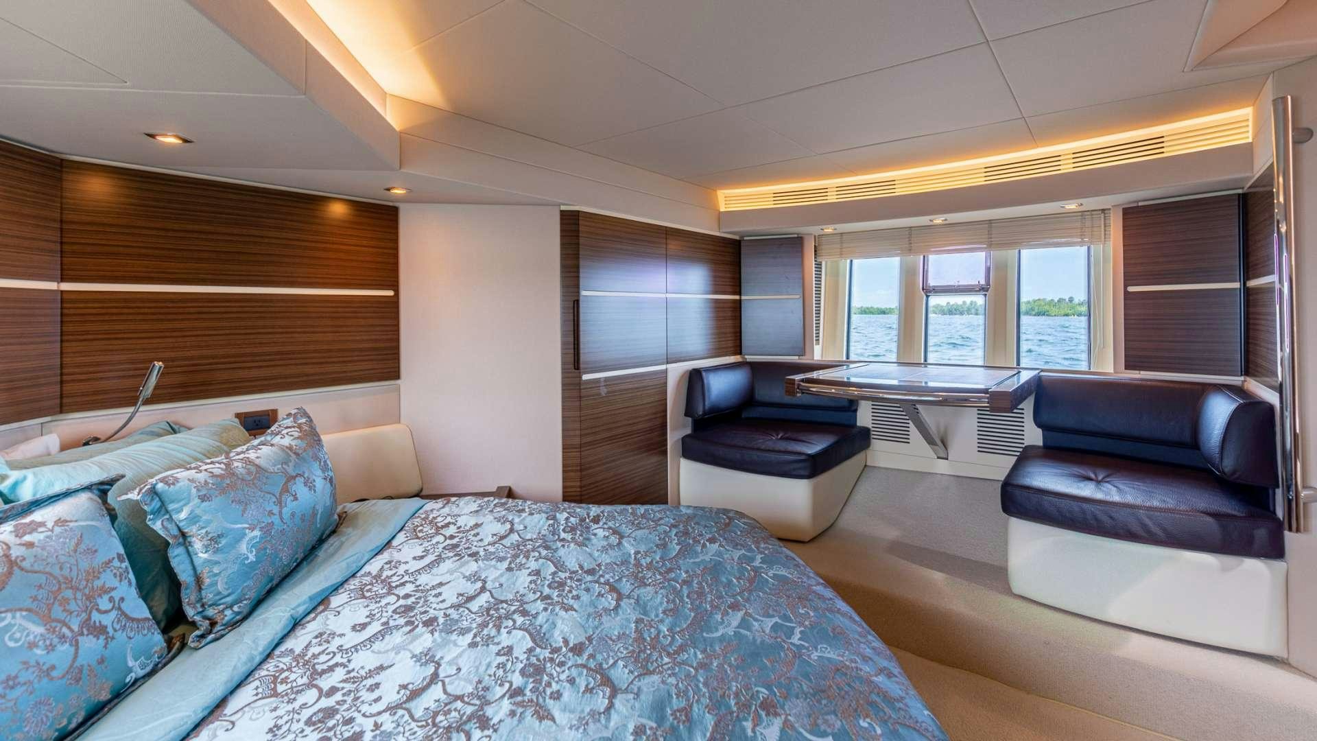 a bedroom with a bed and a couch aboard ROLLIN DEEP Yacht for Charter