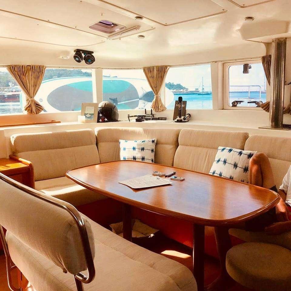 a room with a table and chairs aboard BLACK SHEEP Yacht for Charter