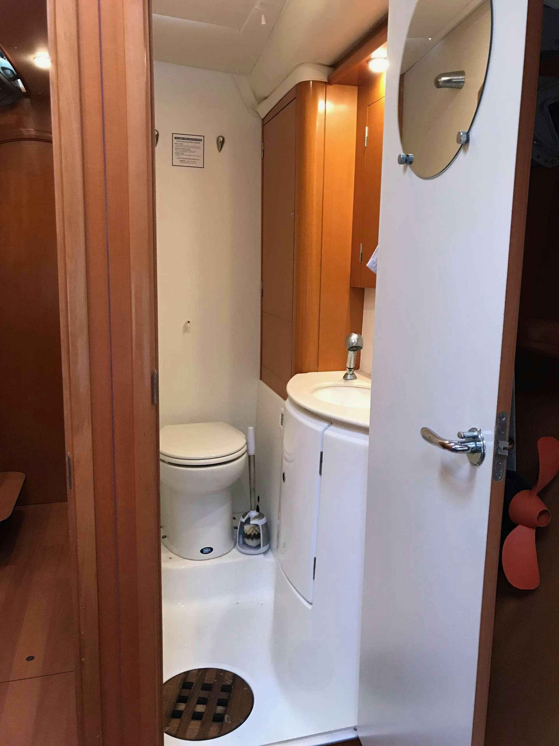 a bathroom with a toilet sink and a bathtub aboard BLACK SHEEP Yacht for Charter