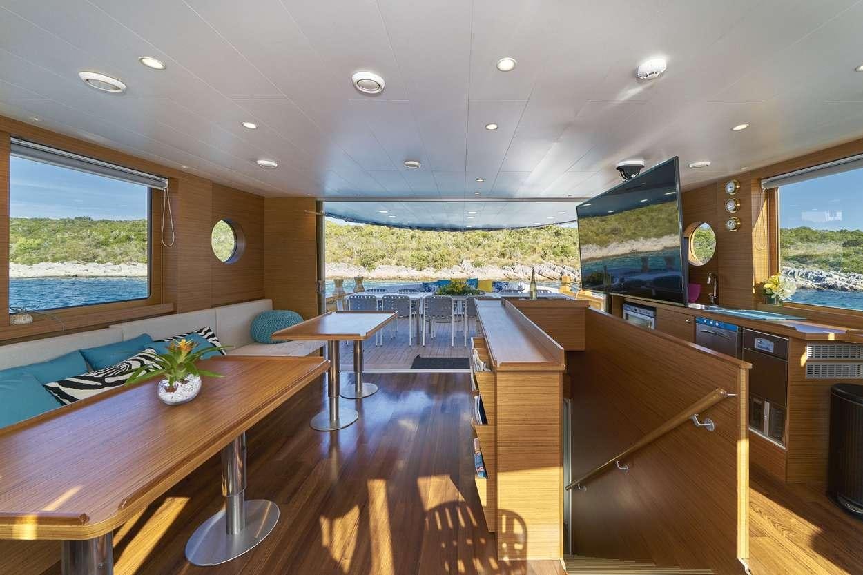 a kitchen and dining area aboard ARDURA Yacht for Charter