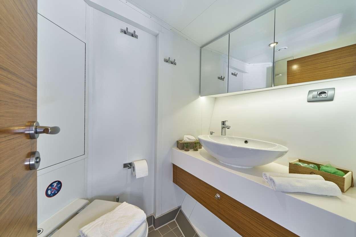 a bathroom with a sink and mirror aboard ARDURA Yacht for Charter