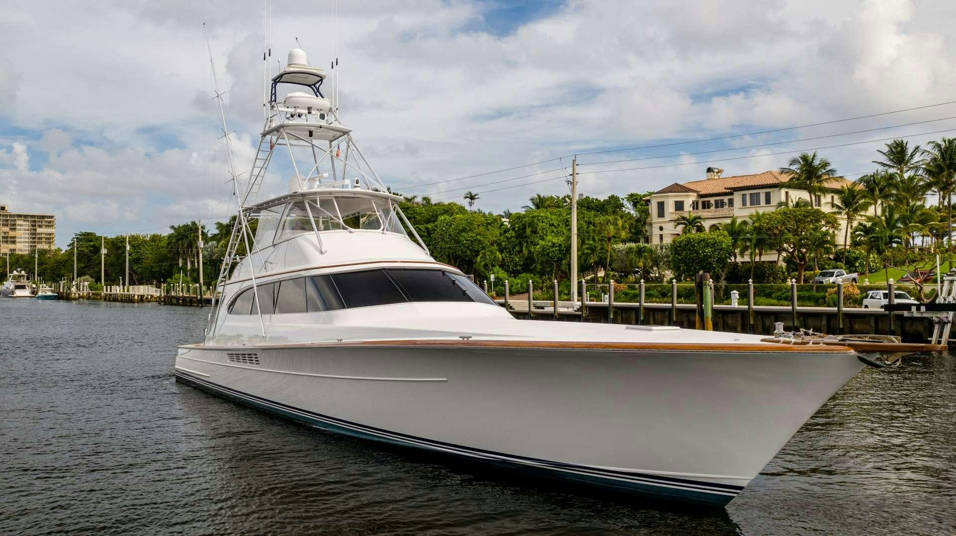 a white boat in a harbor aboard TANGAROA Yacht for Charter