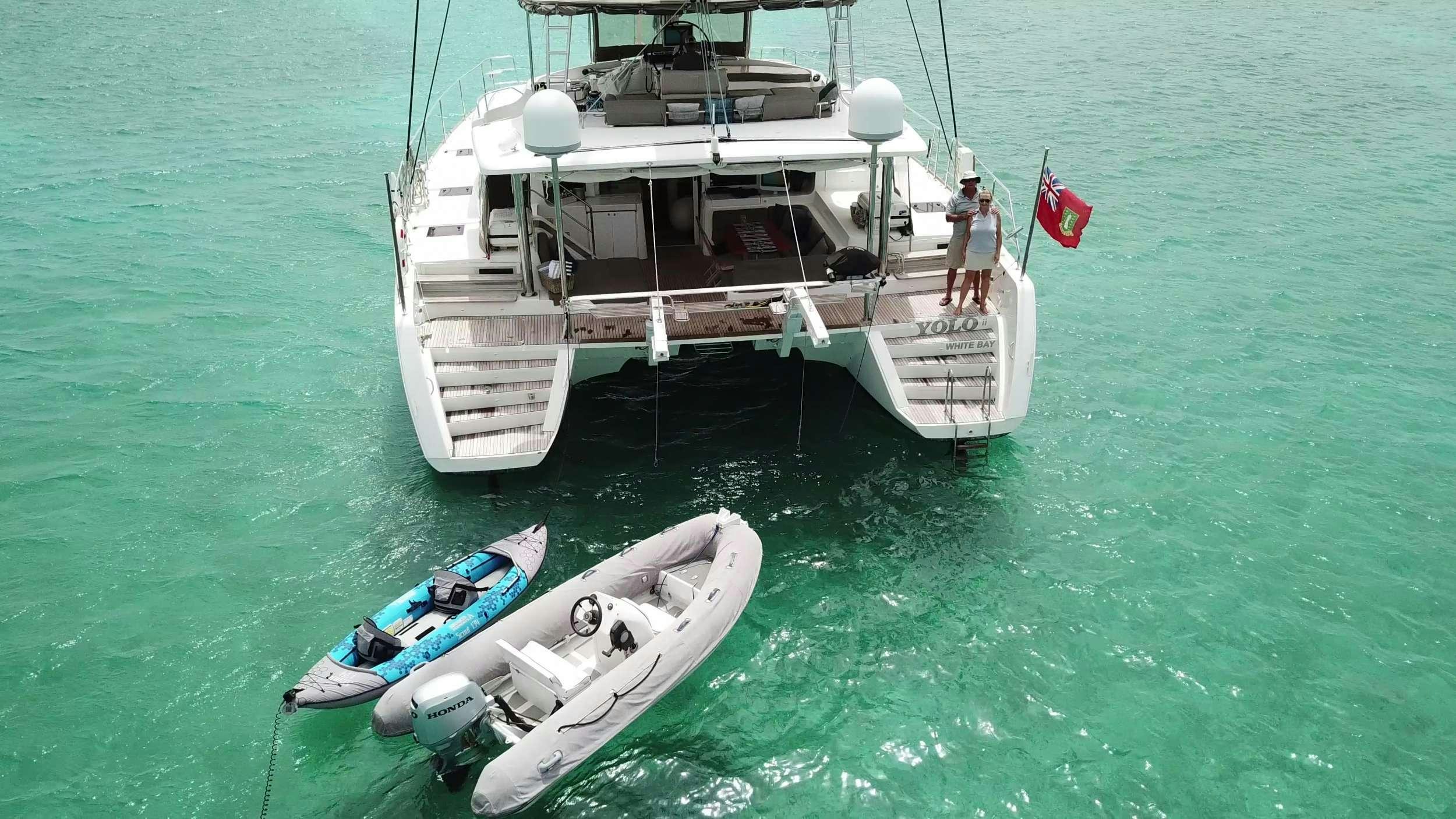 a boat with a flag on it aboard YOLO II Yacht for Charter