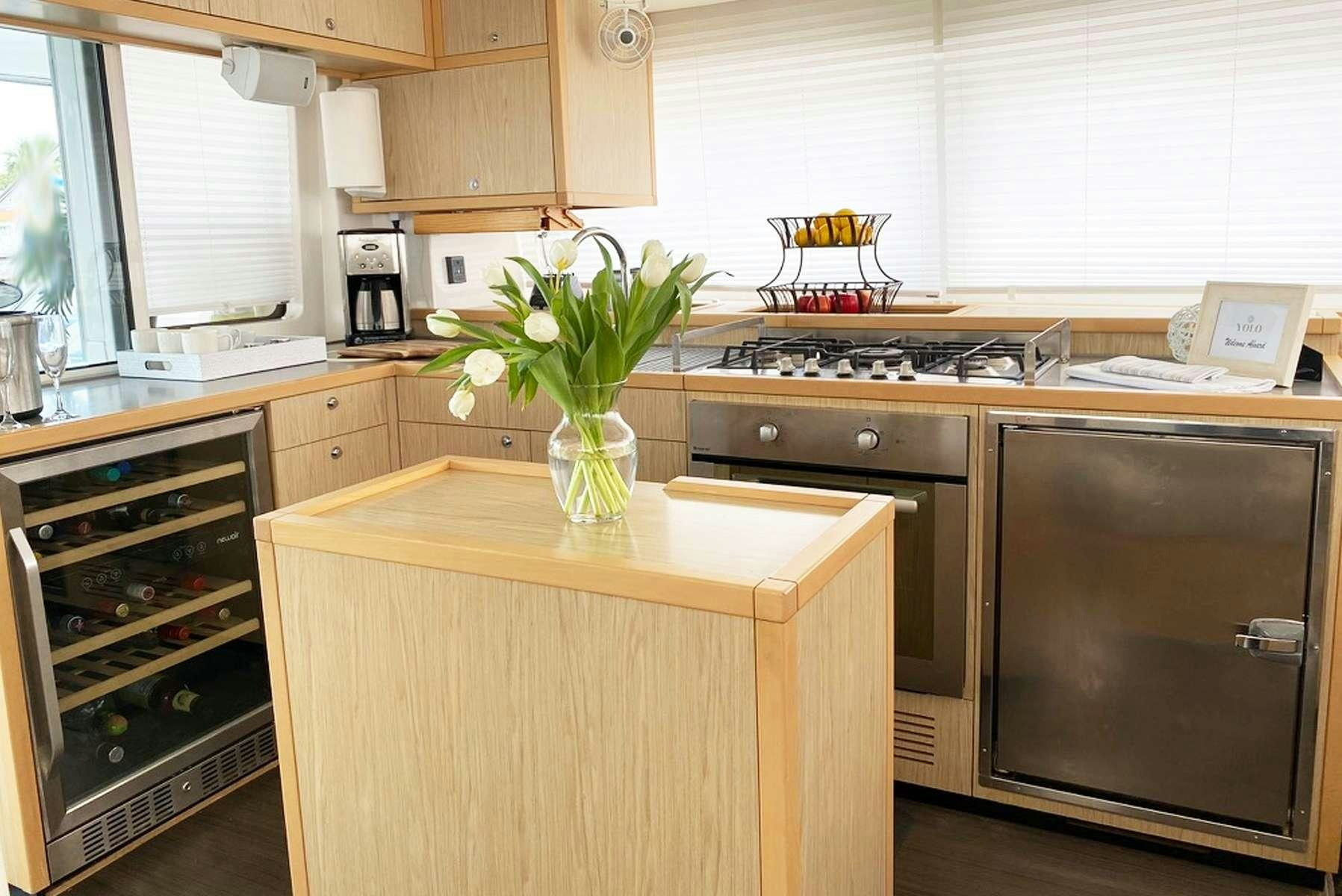 a vase of flowers sits on a counter top aboard YOLO II Yacht for Charter
