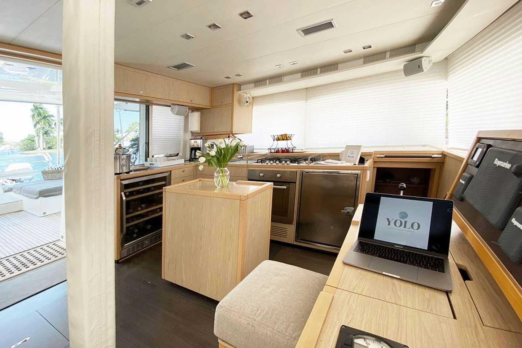 a kitchen with a laptop aboard YOLO II Yacht for Charter