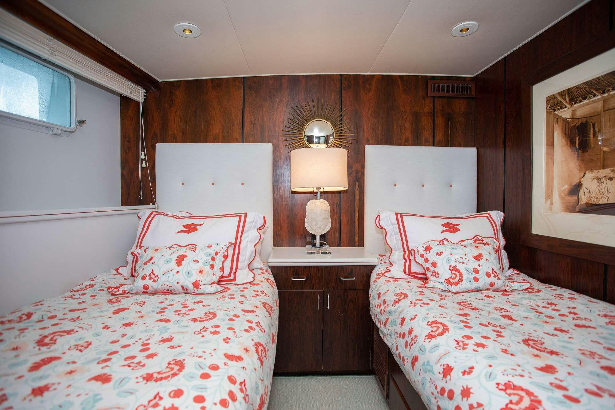 a couple of beds in a room aboard SOVEREIGN Yacht for Charter