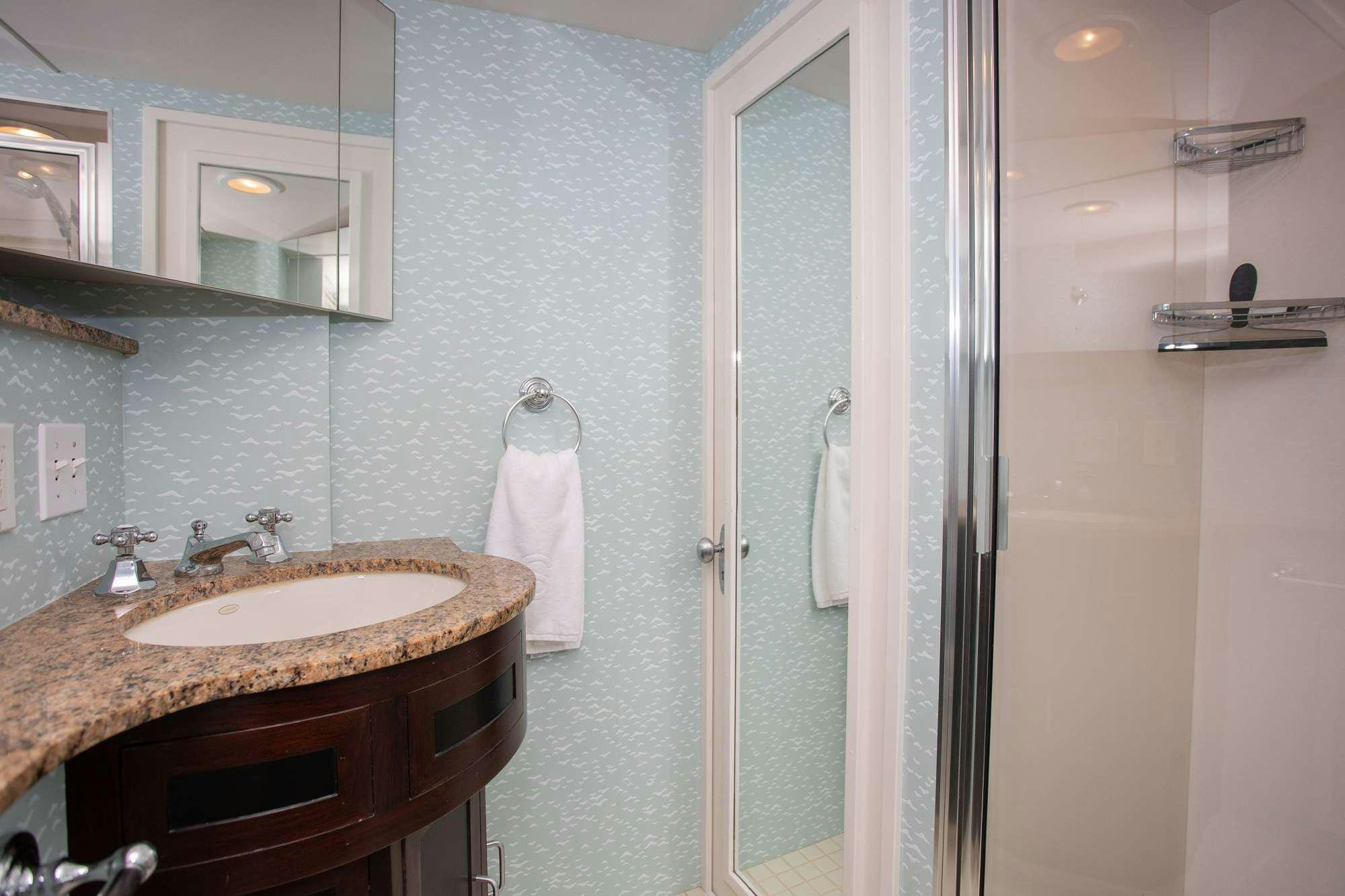 a bathroom with a sink and mirror aboard SOVEREIGN Yacht for Charter