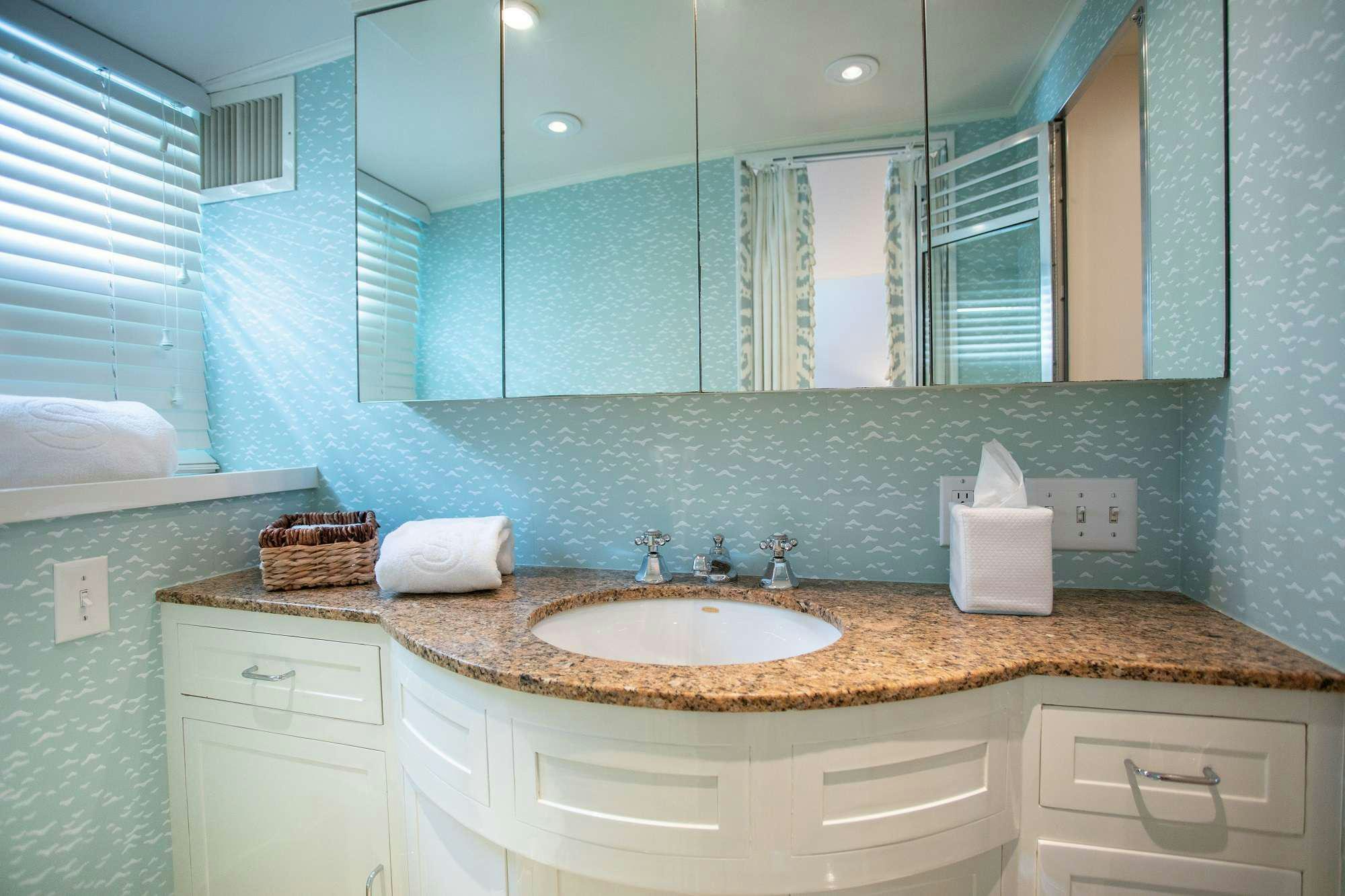 a bathroom with a large mirror aboard SOVEREIGN Yacht for Charter