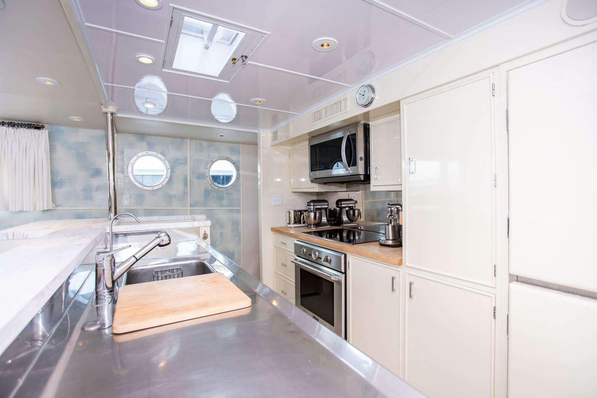 a kitchen with white cabinets aboard SOVEREIGN Yacht for Charter